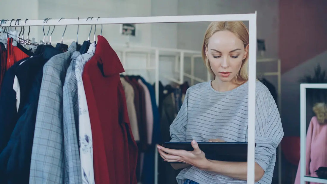 Woman reviews garments in clothing store.